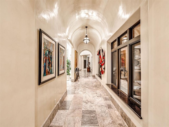 corridor featuring vaulted ceiling