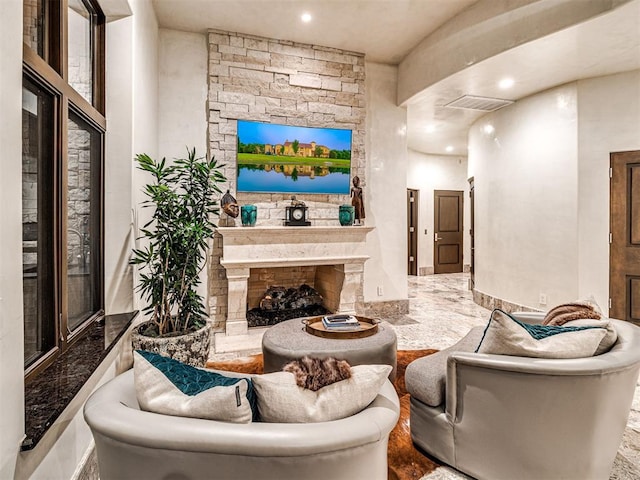 living room with a stone fireplace