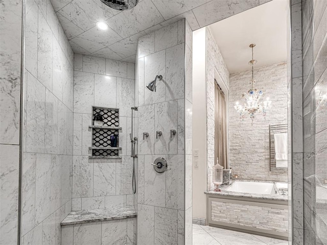 bathroom with plus walk in shower and a chandelier