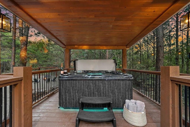 wooden deck featuring a hot tub