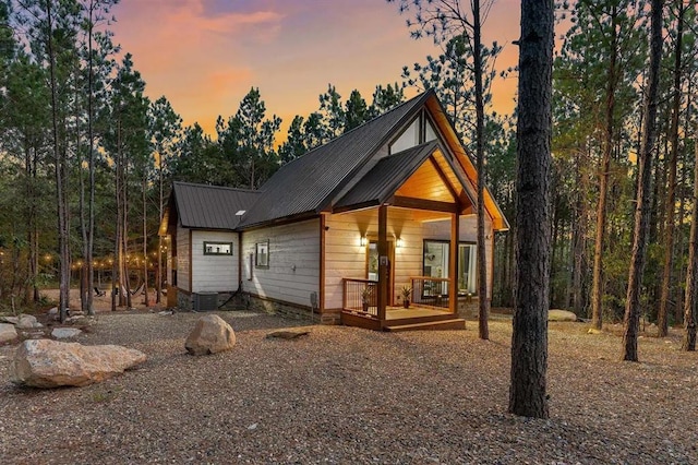 view of front of house with cooling unit and a wooden deck