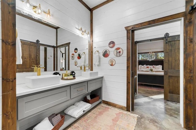 bathroom with vanity, wood walls, and concrete flooring