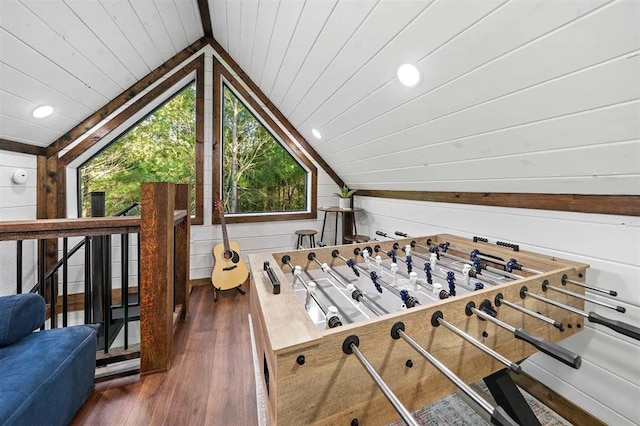 interior details with beam ceiling, hardwood / wood-style flooring, wood walls, and wood ceiling