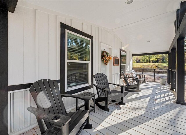 wooden terrace featuring covered porch