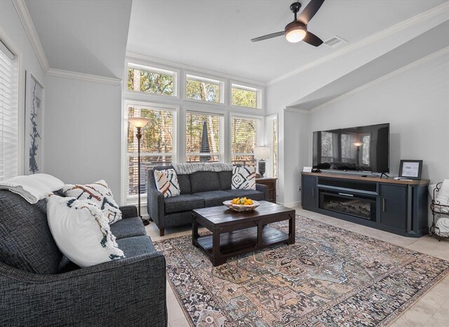 living room featuring ceiling fan, ornamental molding, and light tile patterned floors