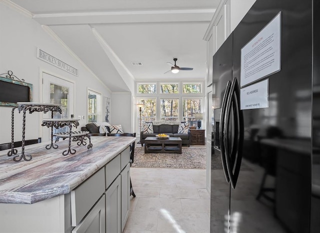 kitchen featuring black fridge, ornamental molding, vaulted ceiling, ceiling fan, and gray cabinets