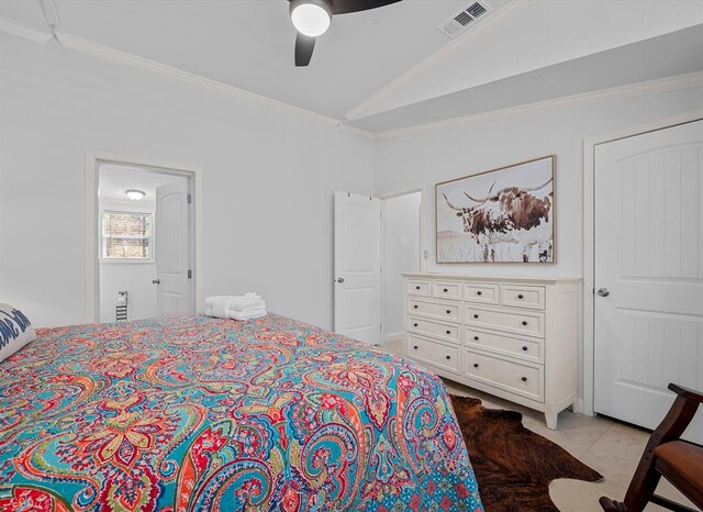 tiled bedroom featuring ceiling fan, lofted ceiling, and ornamental molding