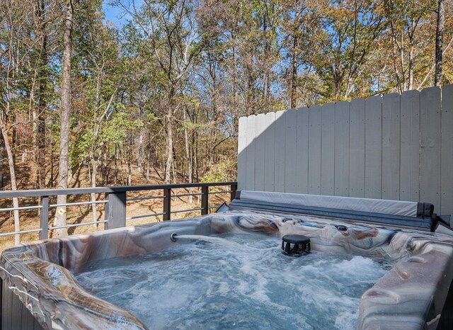 wooden deck with a hot tub