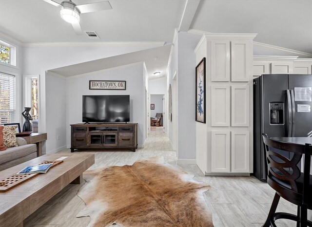 living room featuring ceiling fan, lofted ceiling, and ornamental molding