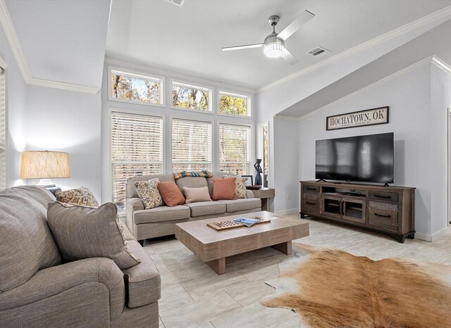 tiled living room featuring ceiling fan and crown molding