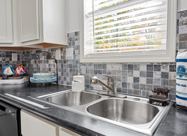 kitchen with backsplash, a healthy amount of sunlight, white cabinetry, and sink