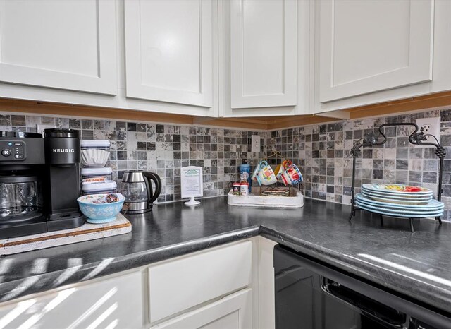 kitchen with white cabinets, decorative backsplash, and dishwasher