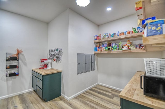 kitchen with hardwood / wood-style flooring, green cabinets, and butcher block countertops