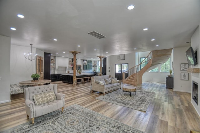 living room with hardwood / wood-style flooring and ornate columns