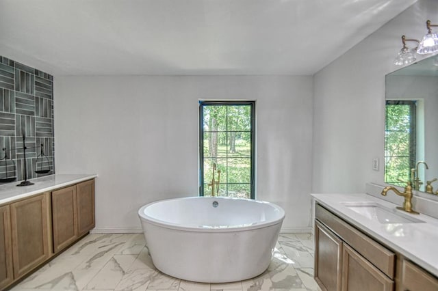 bathroom with vanity and a tub