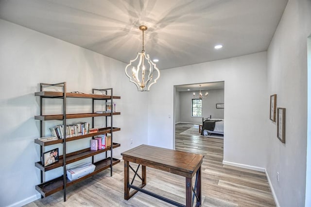 interior space with wood-type flooring and an inviting chandelier