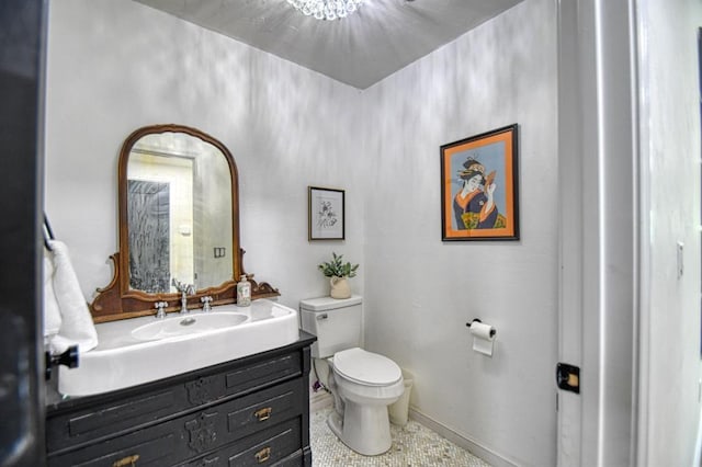 bathroom with vanity, toilet, and tile patterned flooring