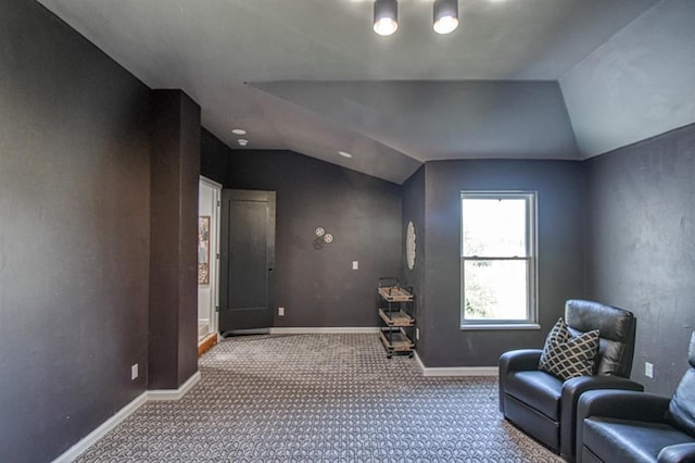 sitting room with vaulted ceiling and carpet