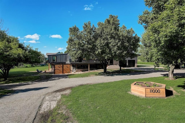 view of property's community featuring a lawn and a deck