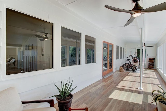 sunroom / solarium featuring a ceiling fan and plenty of natural light