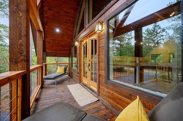 unfurnished sunroom with lofted ceiling and wood ceiling