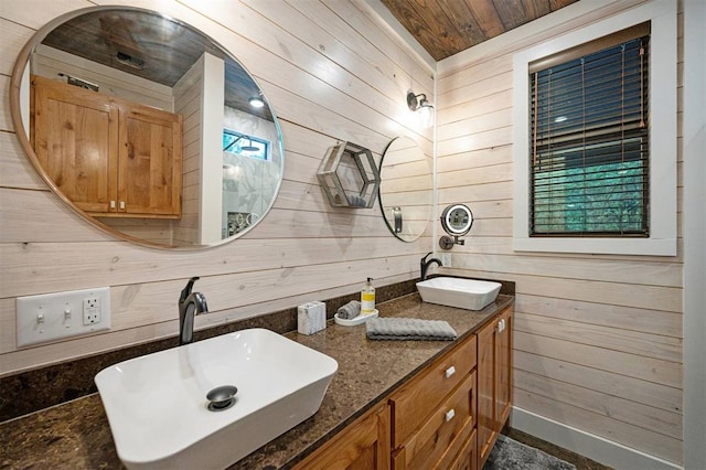 bathroom featuring a wealth of natural light, wooden walls, vanity, and wooden ceiling