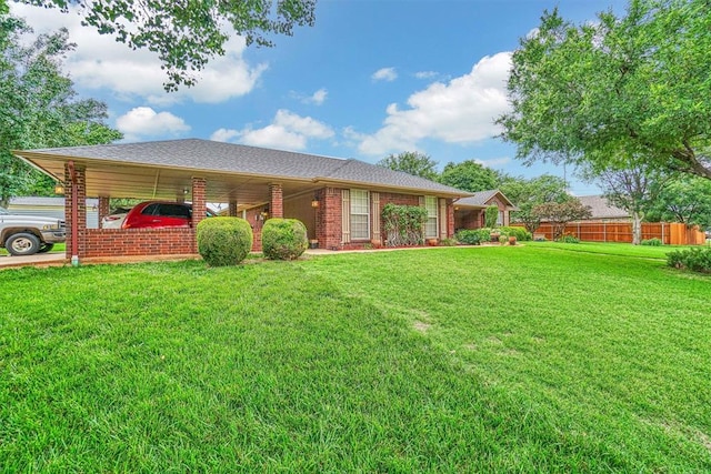 view of front facade featuring a front yard and a carport