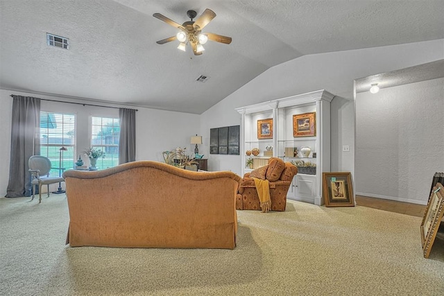 carpeted living room featuring a textured ceiling, vaulted ceiling, and ceiling fan