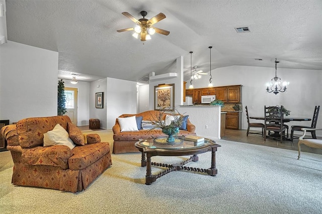 living room with a textured ceiling, ceiling fan with notable chandelier, lofted ceiling, and light carpet