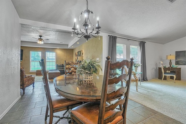 dining area featuring plenty of natural light, a textured ceiling, and ceiling fan with notable chandelier