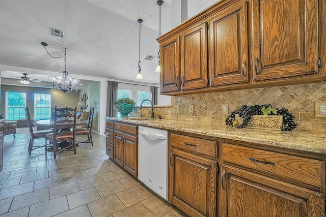 kitchen featuring white dishwasher, plenty of natural light, pendant lighting, and sink