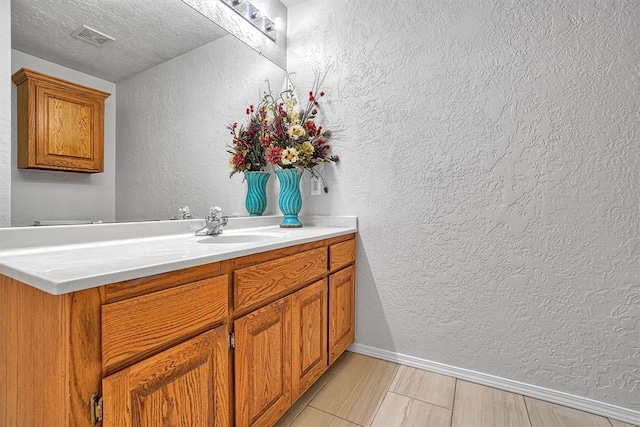 bathroom featuring vanity and a textured ceiling