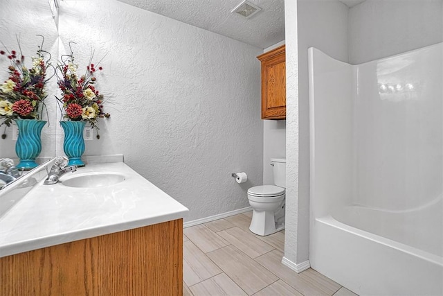 full bathroom featuring vanity, toilet, shower / bath combination, and a textured ceiling