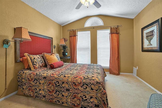 carpeted bedroom featuring a textured ceiling, vaulted ceiling, multiple windows, and ceiling fan