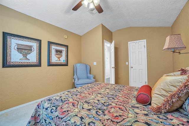 carpeted bedroom with a textured ceiling, vaulted ceiling, and ceiling fan