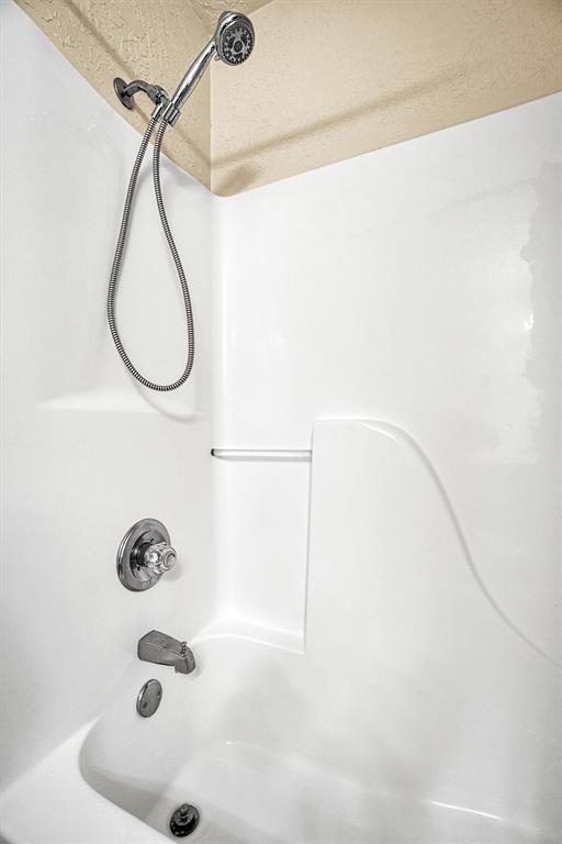 bathroom featuring washtub / shower combination