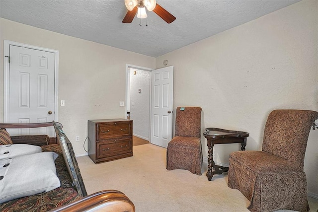 interior space featuring a textured ceiling and ceiling fan