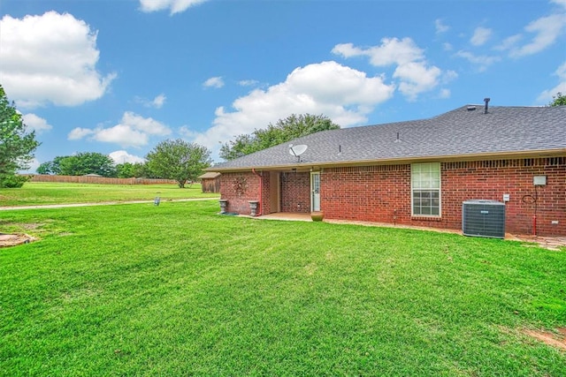 back of property with a lawn and cooling unit