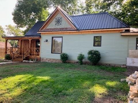 rear view of house with a lawn