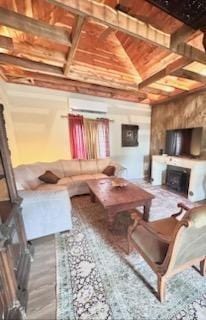 living room featuring beam ceiling and wooden ceiling