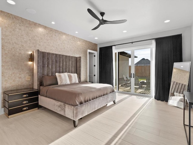 bedroom featuring access to outside, light hardwood / wood-style flooring, and ceiling fan