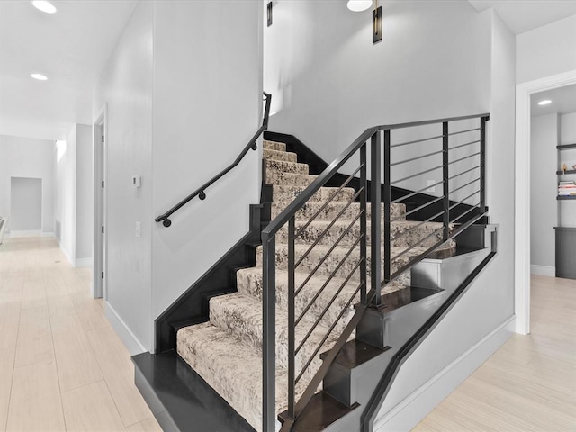 stairs featuring hardwood / wood-style floors