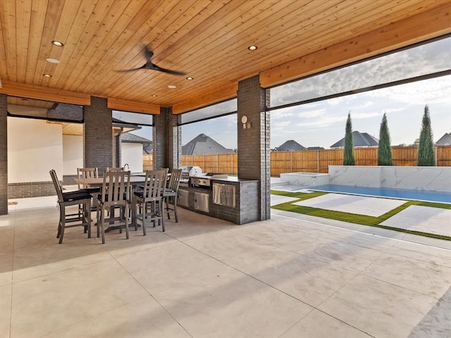 view of patio / terrace with a fenced in pool, area for grilling, and ceiling fan