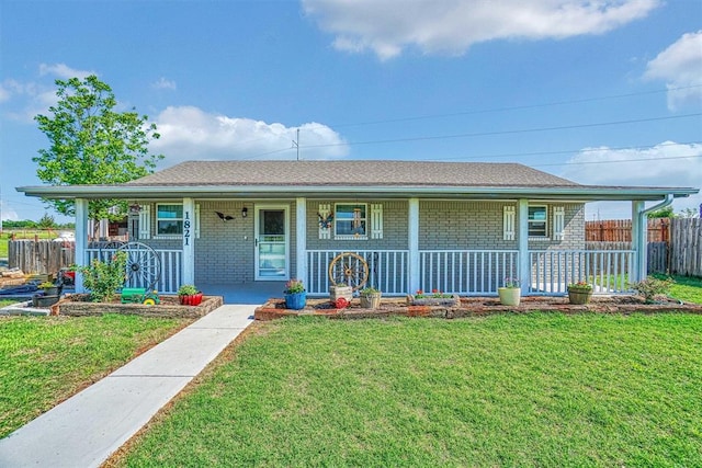 single story home featuring covered porch and a front yard