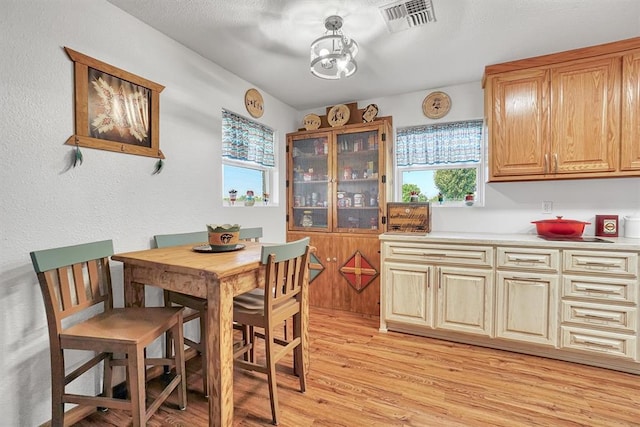 dining area with light hardwood / wood-style flooring and a wealth of natural light