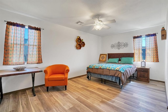 bedroom with light hardwood / wood-style flooring and ceiling fan