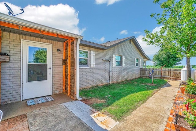 doorway to property featuring a yard