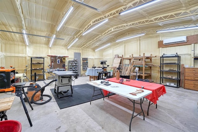 game room featuring a workshop area, vaulted ceiling, a wall mounted AC, and concrete floors