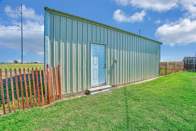 view of outbuilding featuring a yard