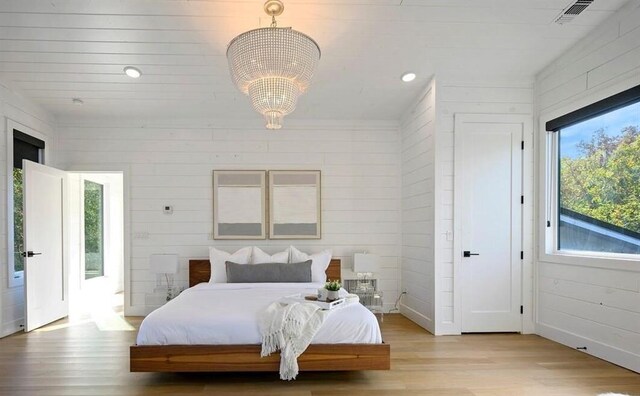 45 Pecan Trace Trl, Broken Bow, OK 74728 - bedroom with light wood-type flooring and a notable chandelier